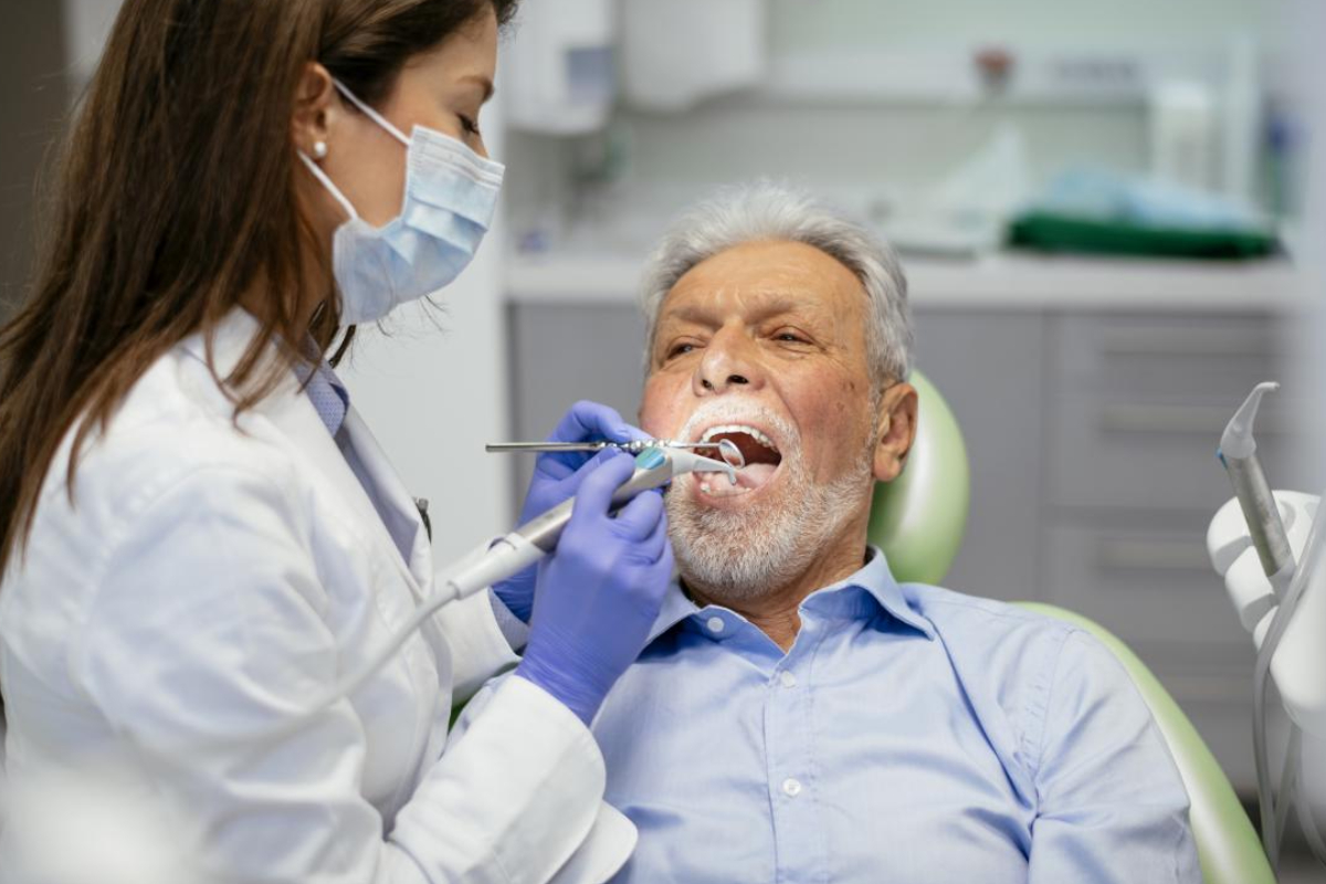 An Image Representing Senior man taking dental treatment in a leading dental clinic.