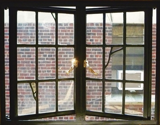 Old large metal window in a historic building 